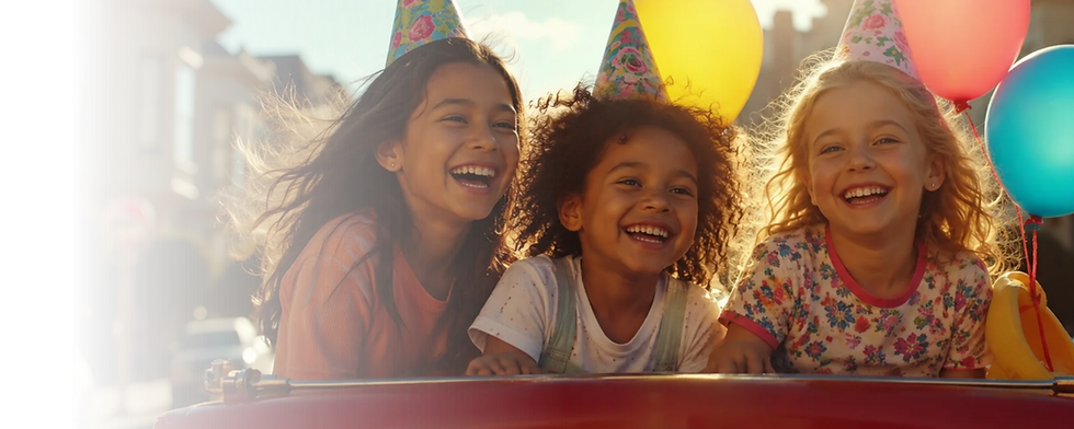 Children with balloons and birthday hats on the vintage fire engine.