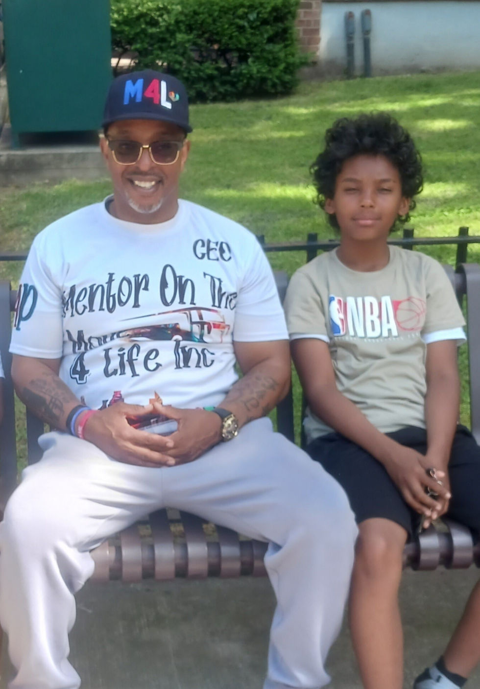 man sitting on a bench between two boys