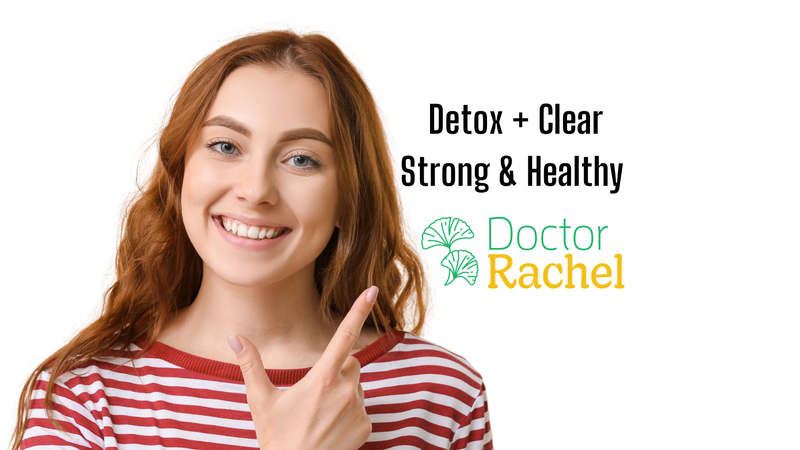 a woman points to a sign that says " detox + clear strong & healthy "