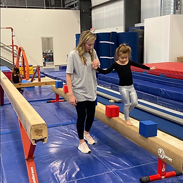 Orange Gym
Located in Mini Moxie upstairs, this class is designed specifically for 3-year-olds. It introduces foundational gymnastics skills, focusing on coordination, strength, and balance.
Purple Gym
Held in Mini Moxie for 4-5 year olds, this class emphasizes developing strong listening skills and mastering foundational elements. Kids build the confidence and abilities needed before progressing downstairs to more advanced classes.
Pink Gym
Located downstairs for 5+ year olds, this beginner-level class focuses on building strength on bars, confidence and balance on beam, and foundational skills like handstands, cartwheels, and forward rolls.
Yellow Gym
Our Beginner 2 class downstairs, Yellow Gym requires an evaluation before kids can move up from Pink Gym. This class builds on foundational Pink Gym skills and introduces new challenges such as backward rolls, handstand bridges, backbends, and bridge kickovers.
White Gym
Our intermediate class, White Gym requires an evaluation before moving up. Here, gymnasts work toward mastering skills like back handsprings, pullovers, and back hip circles on bars, while also building confidence through a variety of challenging beam exercises.
Superstars
Superstars is our advanced class where gymnasts begin combining all the skills they have learned and have the opportunity to showcase their routines.
Each program is led by experienced coaches who focus on safety, skill progression, and encouraging each gymnast to reach their potential. If you would like to find out more about what the classes are working towards, then please email or talk to our coaches.