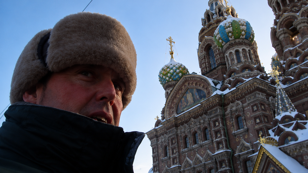 Paul Rushworth-Brown standing in winter clothing beside the Church of the Savior on Spilled Blood in St Petersburg, Russia.