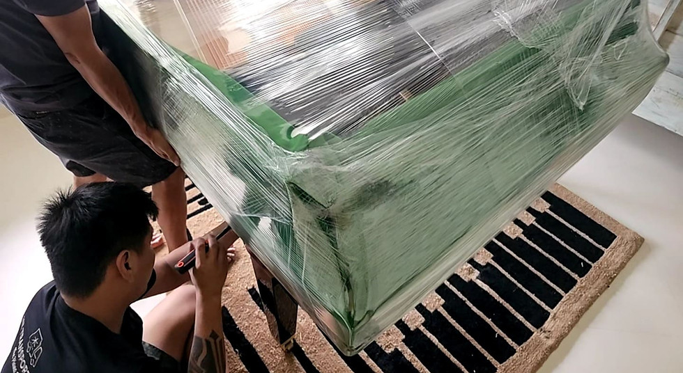 Team of piano movers transporting a grand piano carefully through a residential space