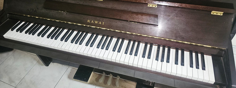 Professional piano disposal service in Singapore removing an upright piano safely from a home.