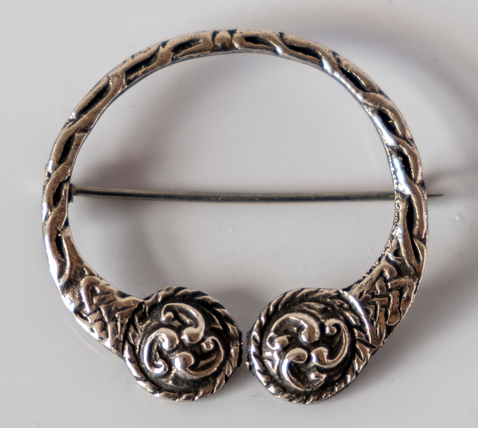 A vintage penannular silver brooch with Celtic knot design