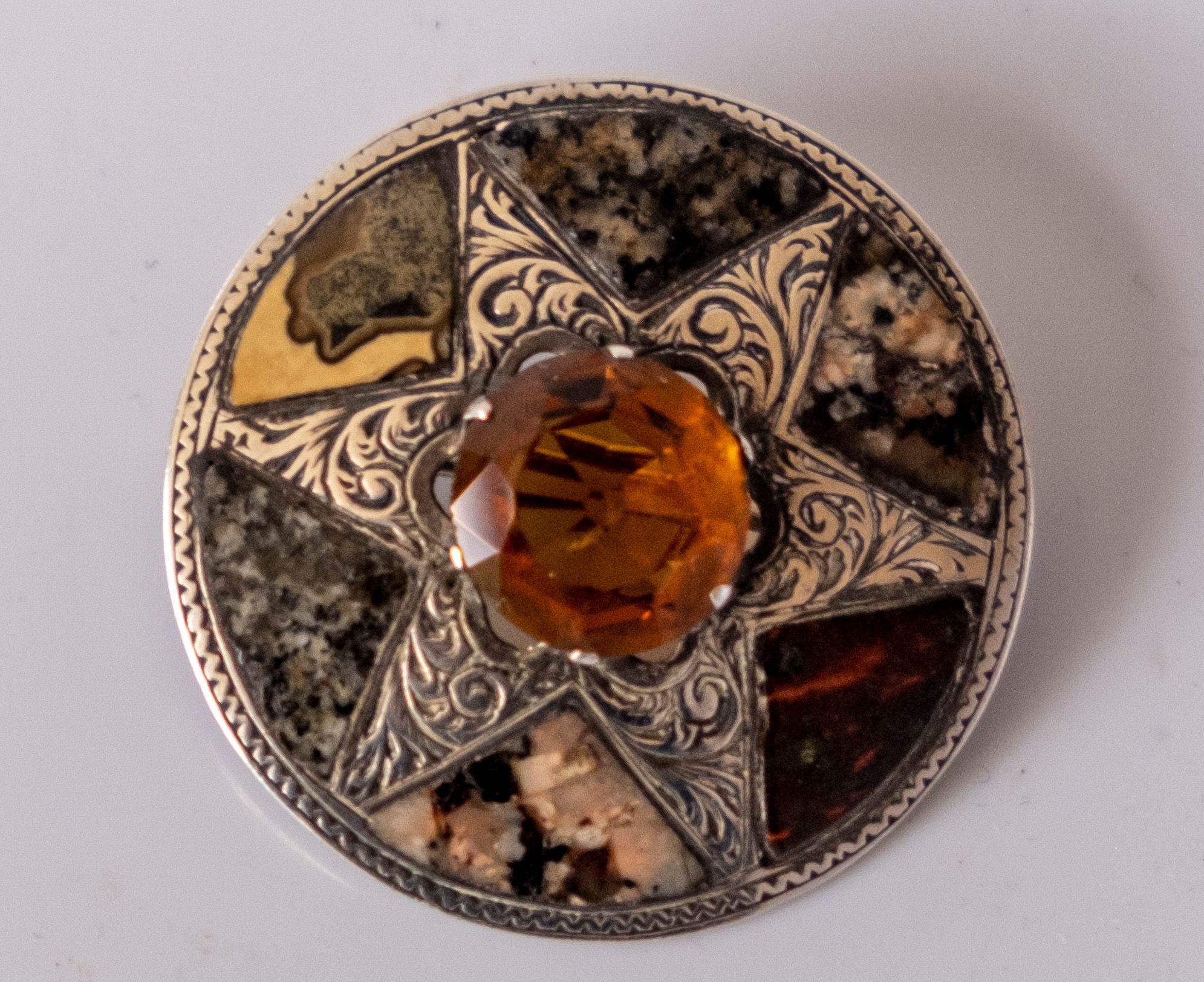 A Victorian Scottish hardstone and citrine silver set shield brooch