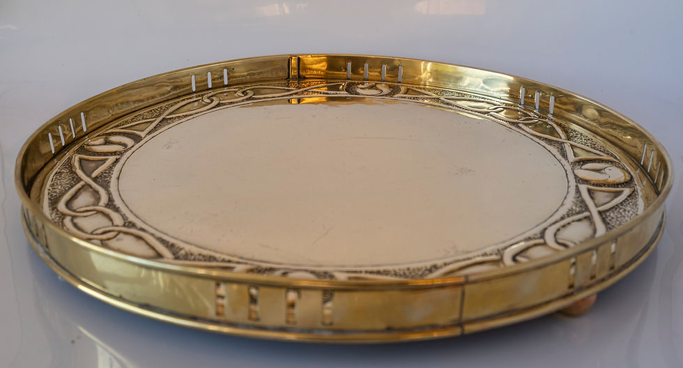 An attractive Glasgow School Arts & Crafts circular brass pierced bordered tray with Mackintosh style boteh quarters