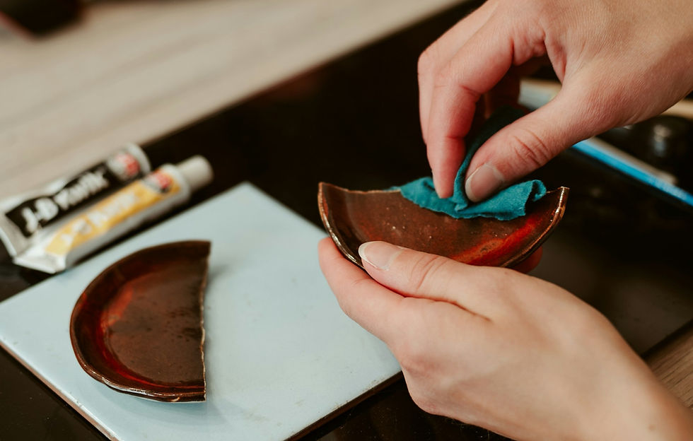 Person repairing a broken pot