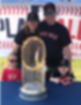 The Murphy family smile behind the 2013 Red Sox World Series trophy. Georgia, Susan, Peter and Donovan smile together wearing baseball attire.