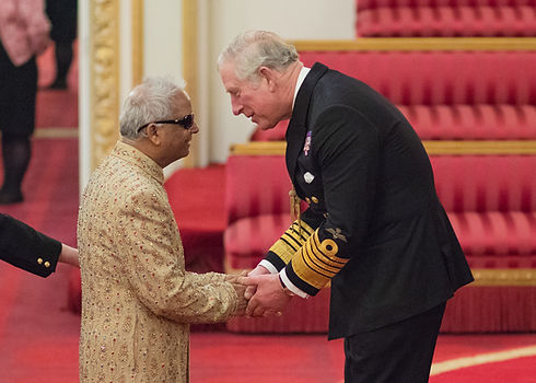 Prince Charles giving OBE medal at Buckingham Palace.jpg