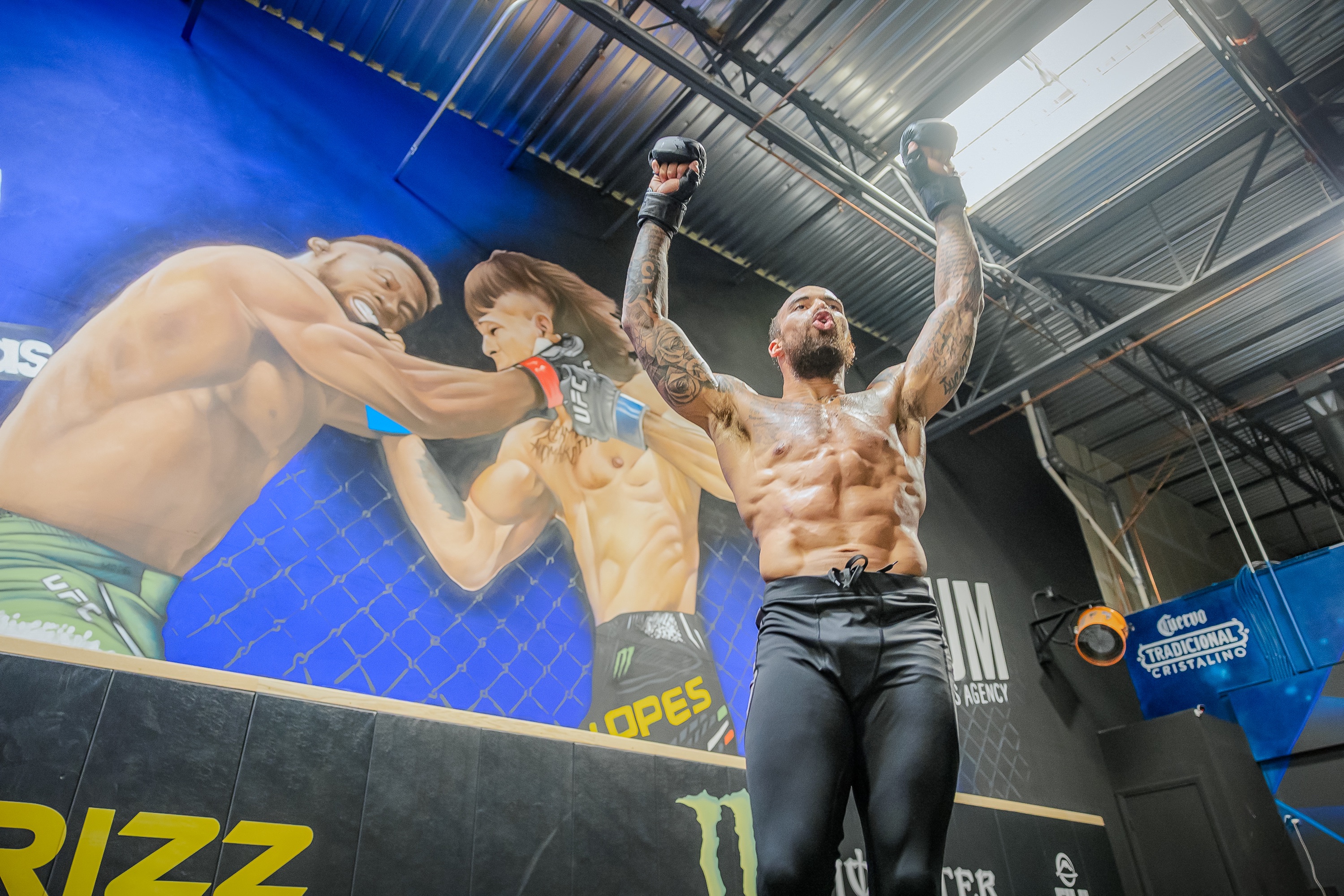 AJ Hotchkins with his arms raised in the gym