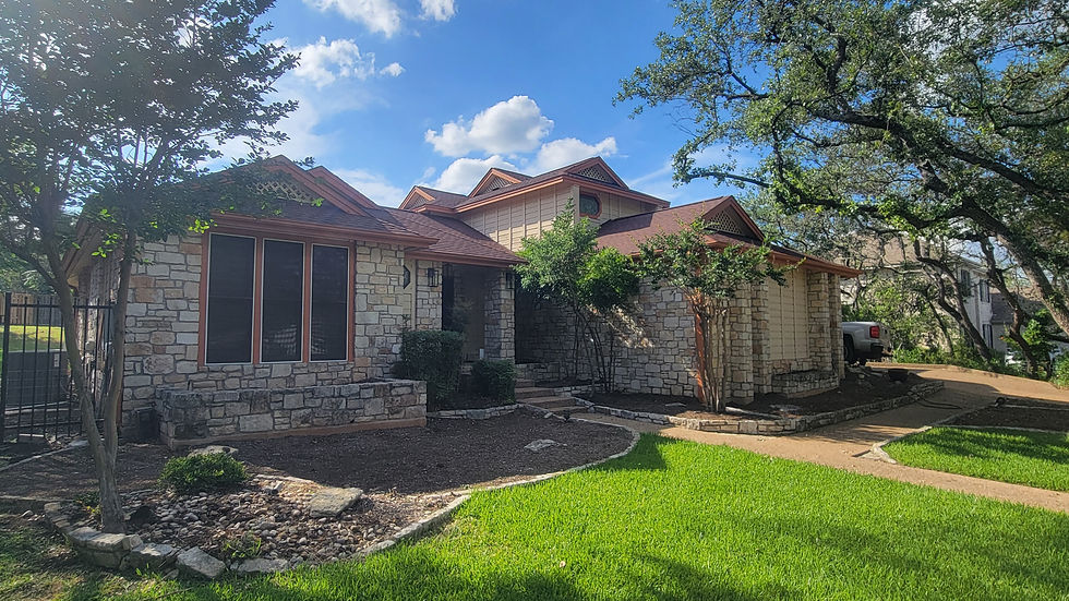 Mocha solar window screens installed on front of Austin stone home