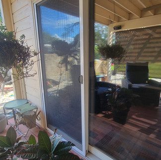 Custom insect sliding door screen on Austin home patio