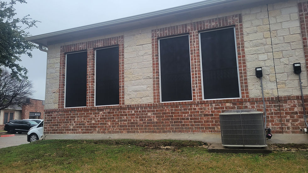 Full view of 90% Round Rock commercial solar screens on office building