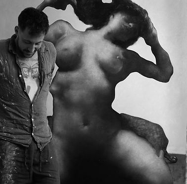 Darian Mederos in his studio with artwork behind
