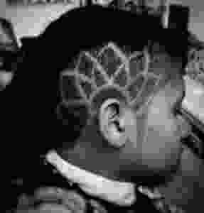 Oblong lines create a lotus flower tattoo above the ear.