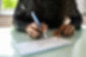 African Woman Writing Check - iStock-1325531612.jpeg