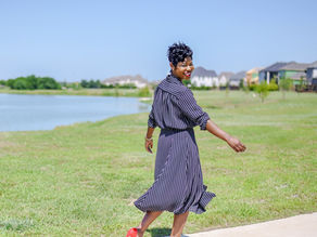 Tiffany Hicks, therapist at Butterfly Effect Counseling, strutting confidently outdoors to symbolize the freedom and empowerment that therapy brings.