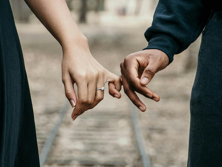 Two people lightly holding hands, representing healthy boundaries and mutual respect in relationships