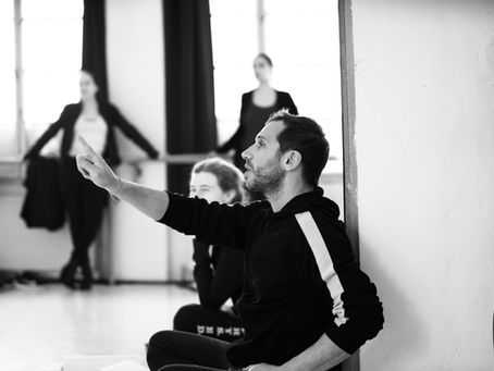 Acting coach in studio speaking with actors.