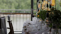 a restaurant table with exposed filament lightbulbs hanging down