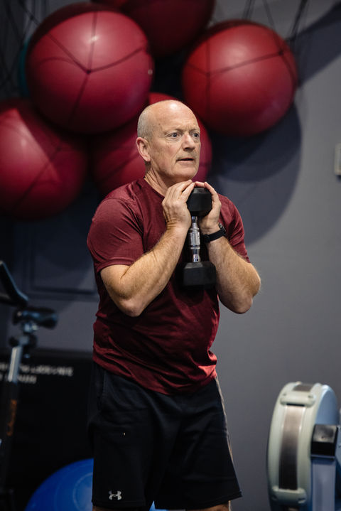 BodyNetix member doing dumbbell front squats in the gym during a group fitness class