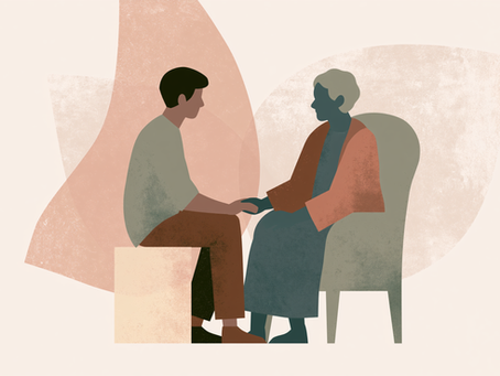 Two people sitting down in chairs; facing each other