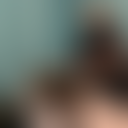 Licensed massage therapist at Ampersand Fitness in Seattle performing a leg stretch technique during a massage session to relieve tension and improve mobility.