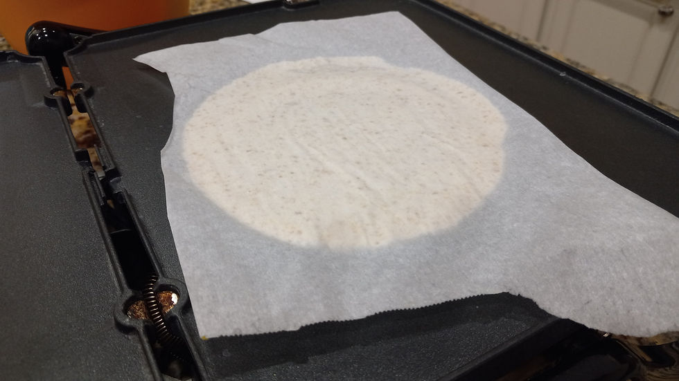 use the parchment to flip pressed tortilla onto hot griddle