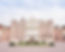 A grand red brick manor house with a central white portico.