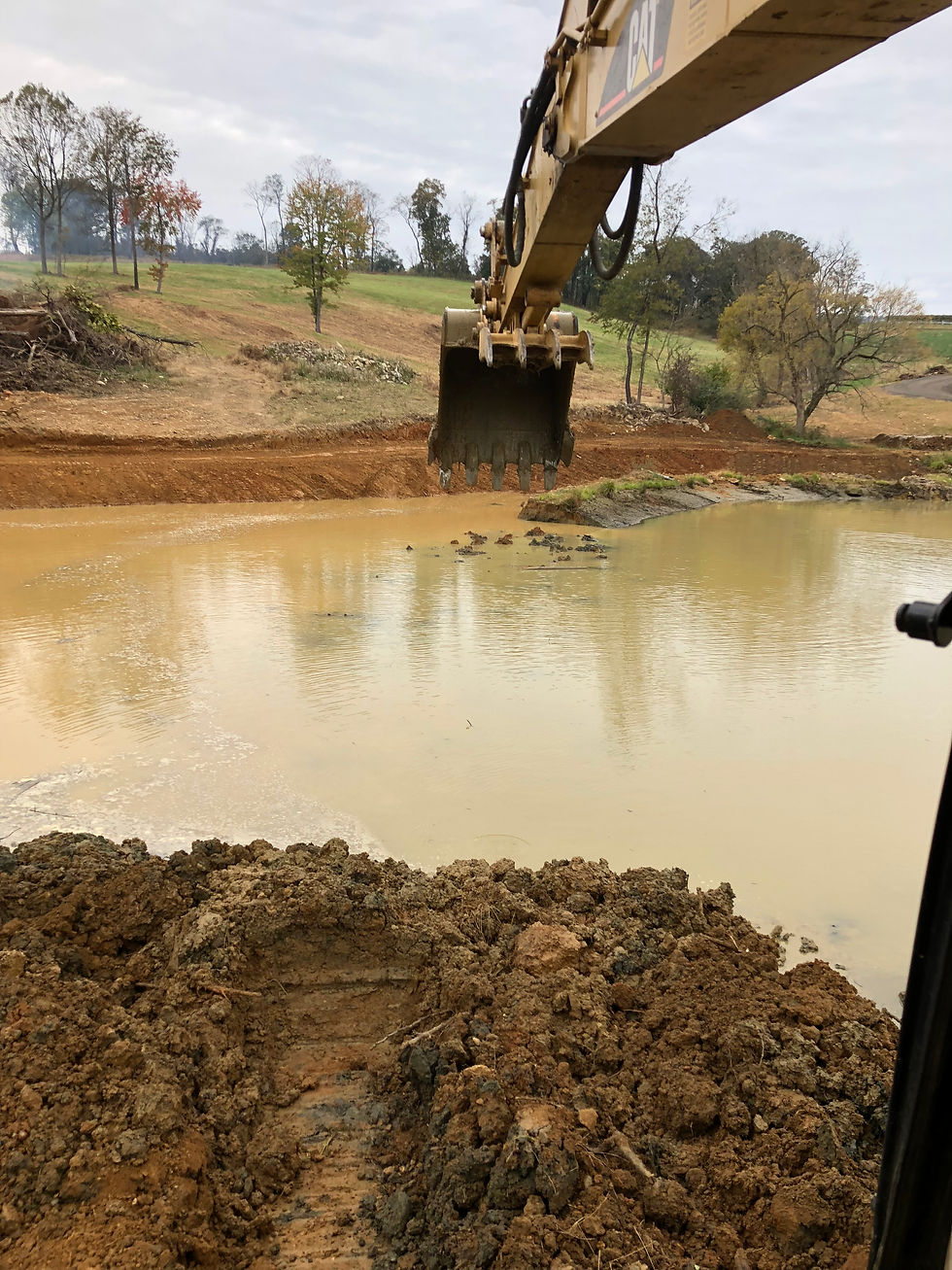 Lucketts Excavating's excavator on a pond installation job.