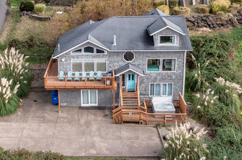 Elevated drone shot of a home, yard, and nearby environment