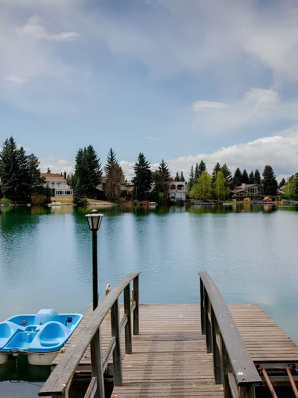 Lake with homes and paddle boat with small dock in Lake Bonavista in the summer