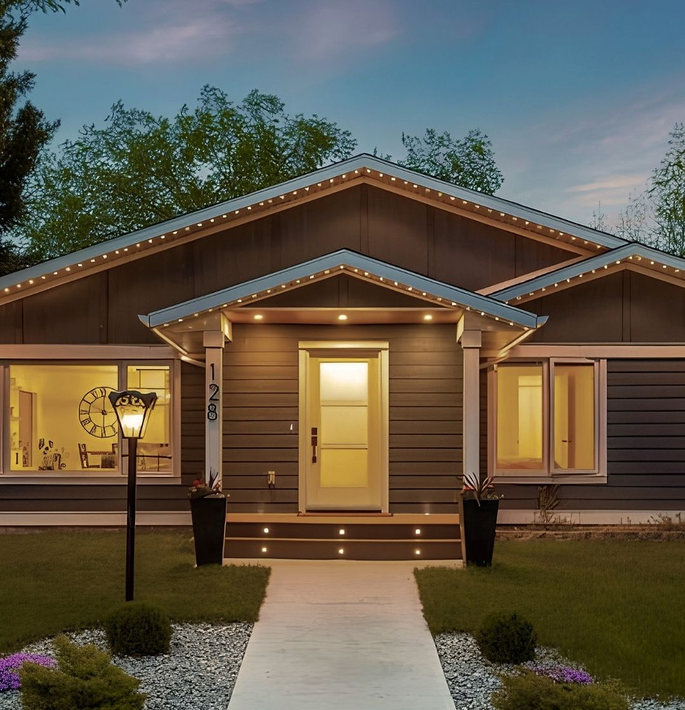 Bungalow home at twilight wih manicured front lawn and glowing lights in doorway and living room