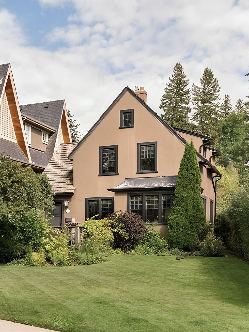 Brown house in summer with triangle roof.