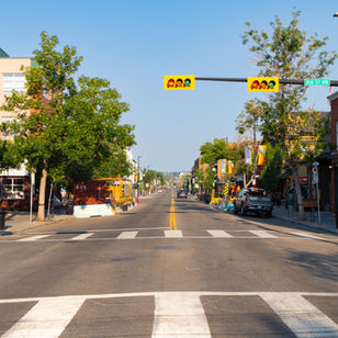 Cute street in Kensington, corner cafe in heritage building, crosswalk and traffic light on a summer morning with bright morning light.