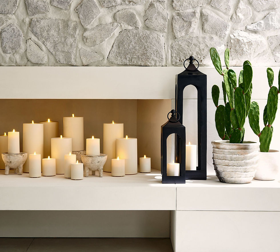 A bunch of flameless candles in a fake fireplace for a cozy feel