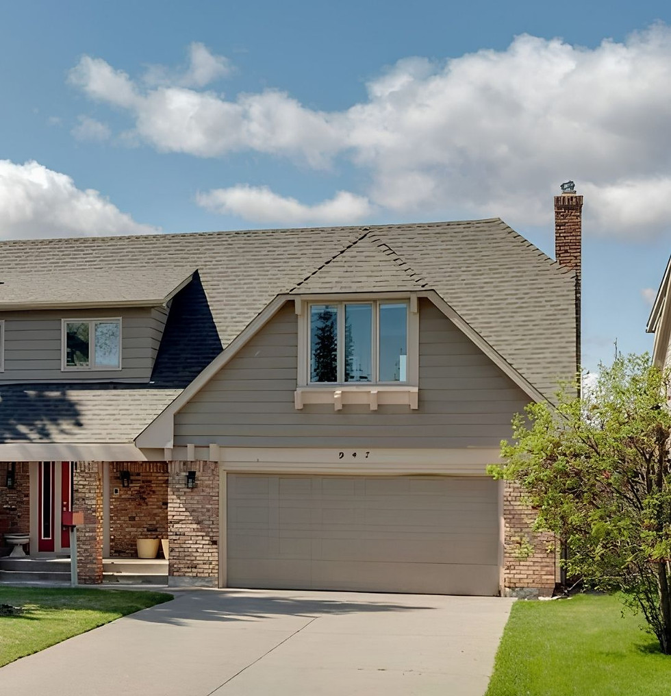 Dutch colonial style roof with 2 car garage and driveway and manicured front lawn