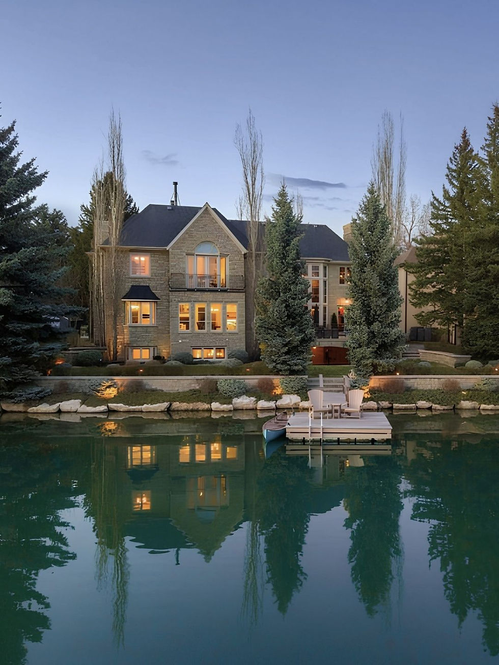 Modern chateau style executive home with lake access and dock with swim step