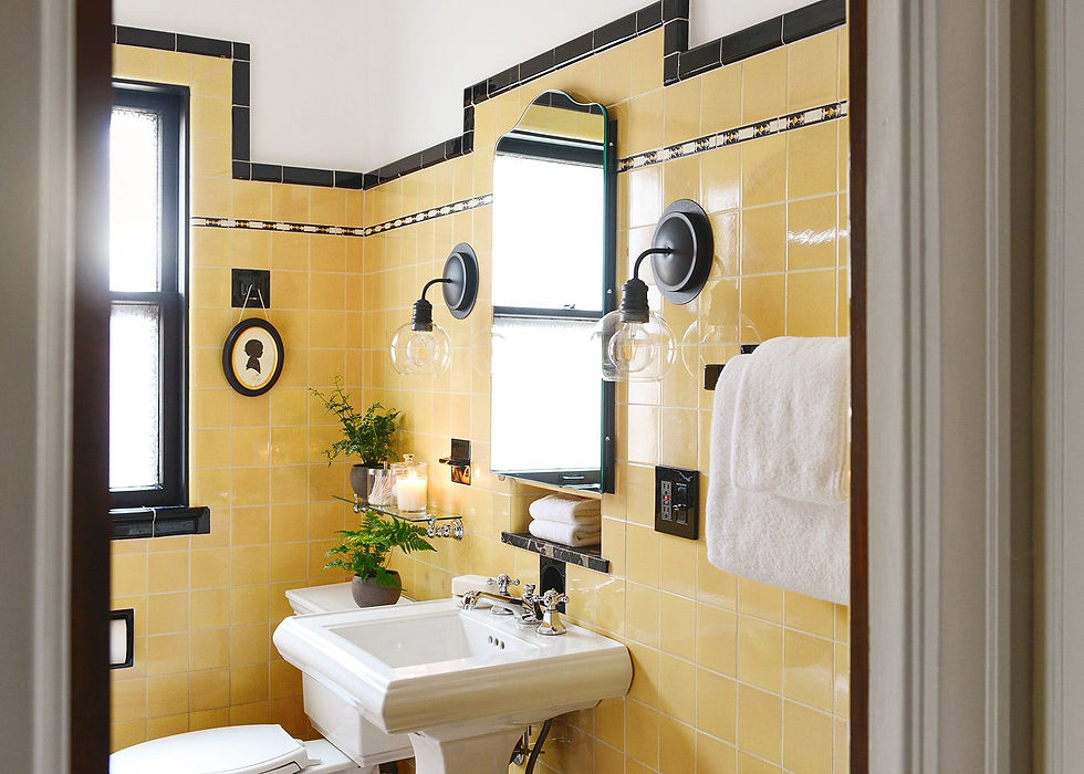 Yellow tiles and black edging tiles in bathroom