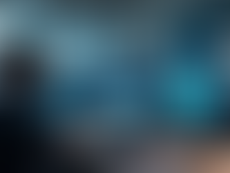 Eye-level view of a modern office workspace with multiple cloud service dashboards on screens