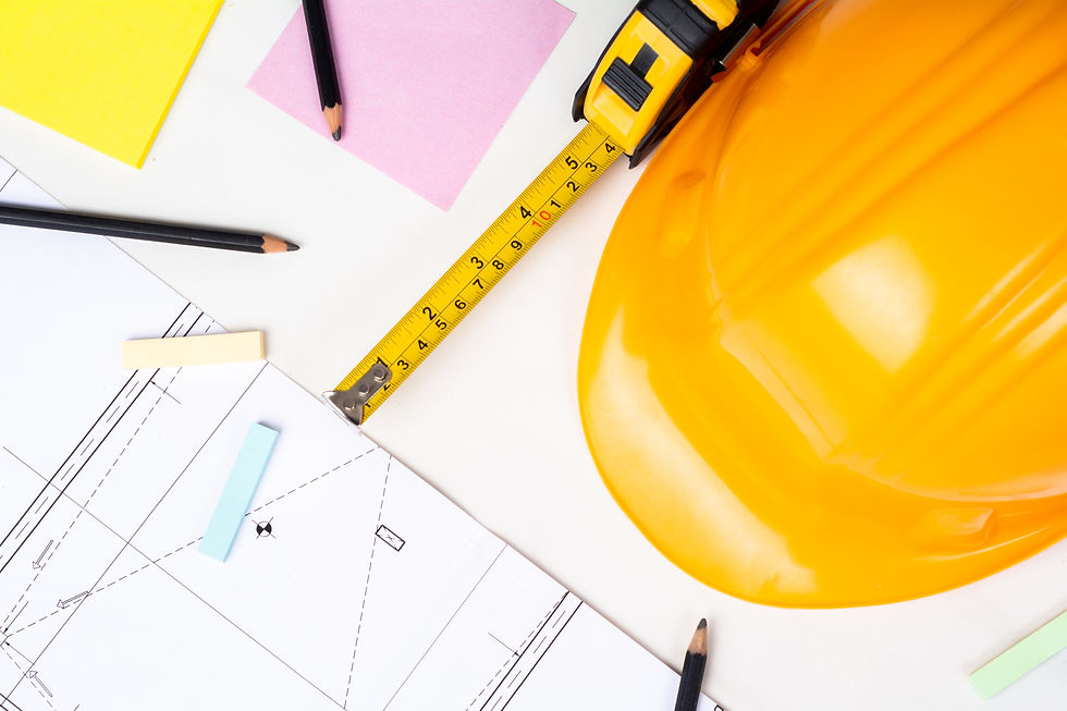 Hard hat with pencils and blueprints to show working in the trades.