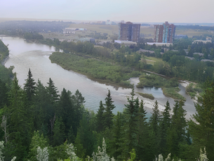 An aerial photo of the Bow River valley in summer