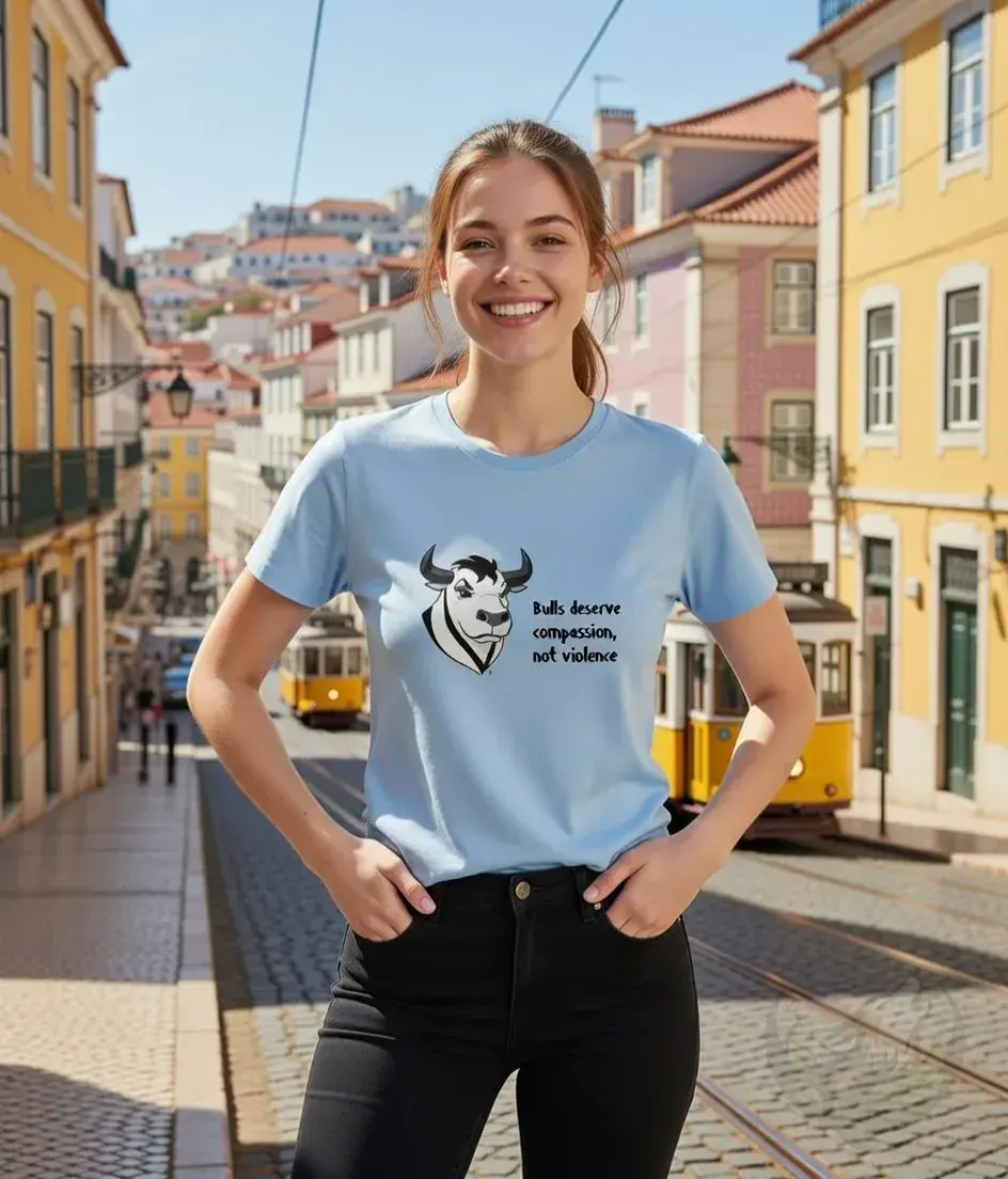 Thumbnail: Light blue fitted tee with the Vegan Quotes “Bulls Deserve Compassion” message worn on a cobblestone street in a city
