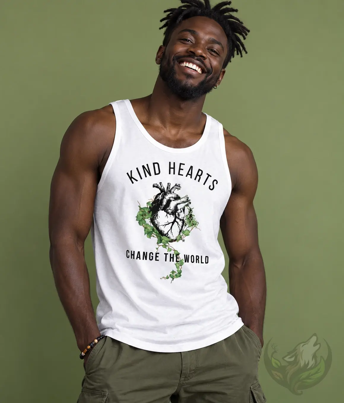 Smiling man wearing white Kind Hearts Change The World tank top against a green background