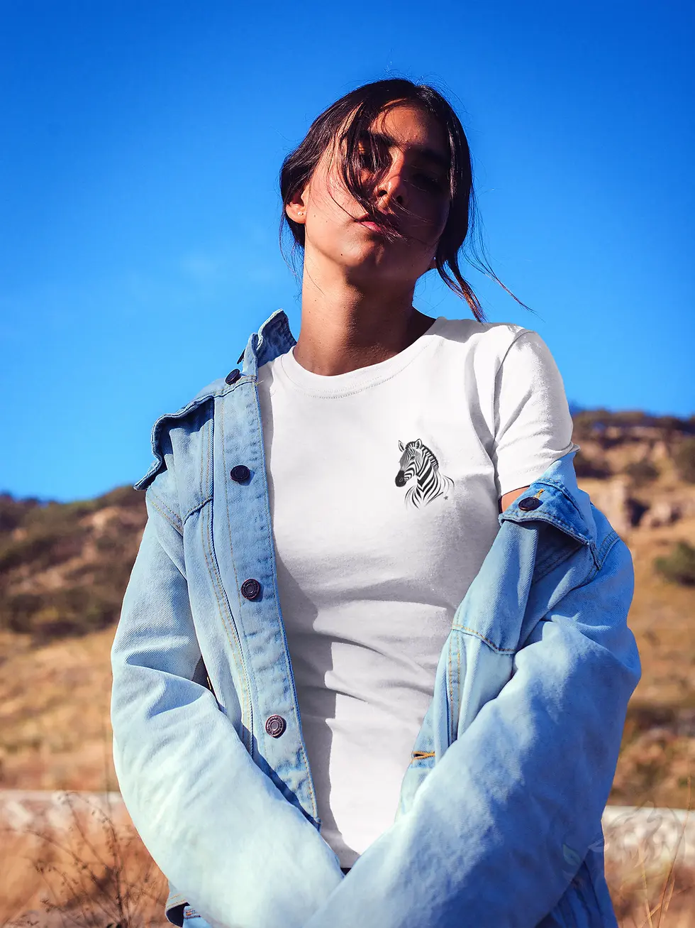 Woman standing outdoors wearing a white fitted t-shirt with a delicate zebra line art on the left chest.