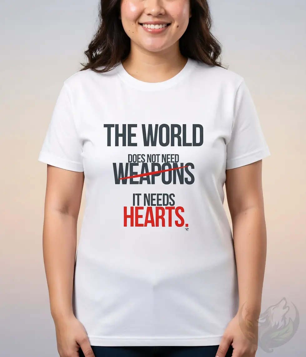 Smiling woman wearing a fitted white t-shirt that reads "THE WORLD DOES NOT NEED WEAPONS" (crossed out in red) "IT NEEDS HEAR
