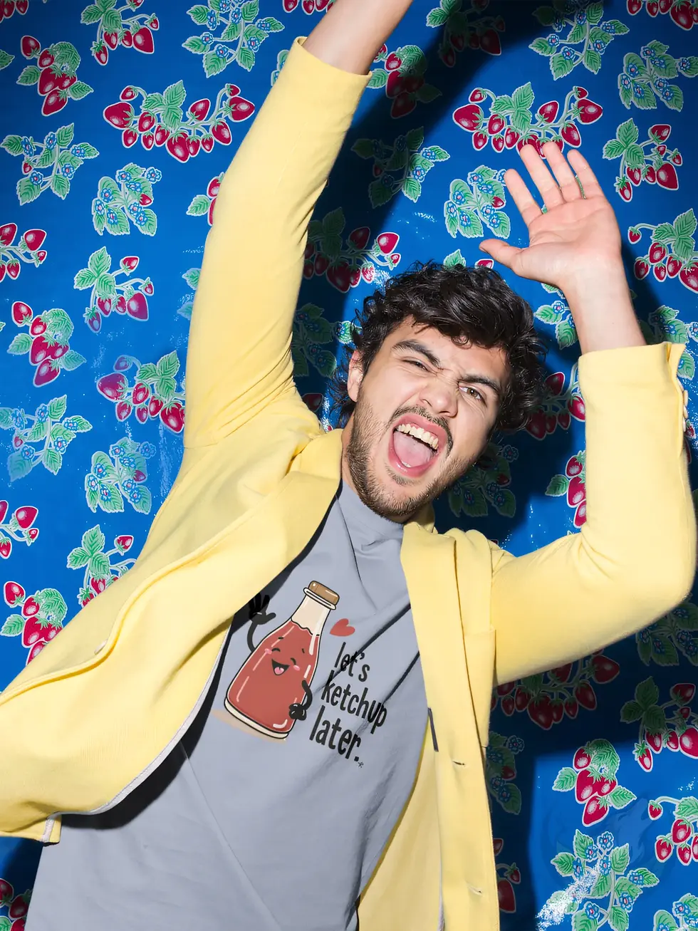 Thumbnail: Playful man wearing light blue Let's Ketchup Later food pun t-shirt at colorful retro party