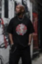 Man wearing black unisex Griffin shirt with fantasy griffin artwork in graffiti street background