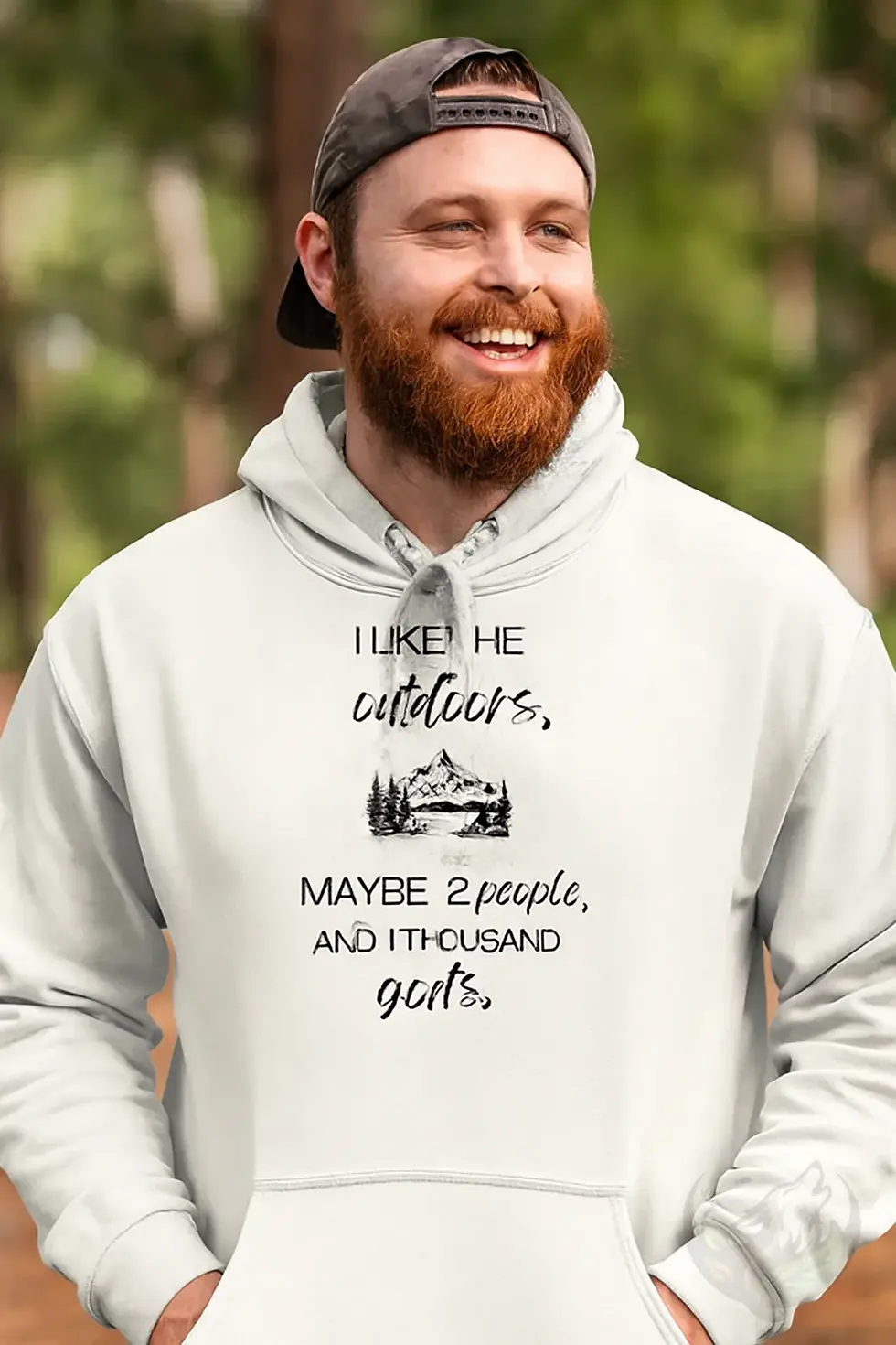 Man wearing a white unisex 1000 Goats outdoors hoodie outdoors in a forest