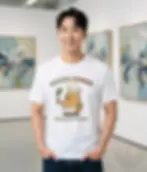 White unisex t-shirt on smiling man in art gallery, "Potato Power! Fuelled By Plants" cartoon illustration.